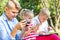 Busy kids looking at their phones texting sms and playing sitting outside