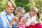 Busy kids looking at their phones texting sms and playing sitting outside