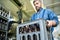 Busy male mover transporting box with beer bottles from plant