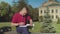 Busy male student answering phone sitting on bench