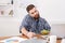 Busy man has vegetarian lunch in modern office interior