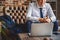 Busy man sitting in front of laptop