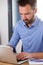 Busy mature man working on laptop at his desk