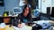 Busy middle-aged woman is sitting at the office table holding a pen in her hand