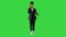 Busy mixed-race woman is talking on the smartphone while walking on a Green Screen, Chroma Key.