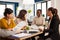 Busy multicultural women employees analysing annual financial statistics