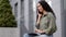 Busy multitasking businesswoman user freelancer worker lady sitting outdoor outside talking mobile phone typing laptop