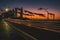 Busy nighttime highway featuring a scenic urban skyline in the backdrop