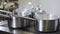 Busy restaurant kitchen concept. Team of chefs and kitchen staff preparing and serving food in commercial kitchen. Rush