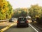 Busy rural highway road in germany with multiple cars, Volkswagen, Peugeot and
