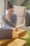 A busy small business owner is on the phone while preparing her parcel boxes