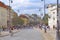 Busy street with pedestrians and cyclists in Warsaw. Woman driving bicycle