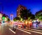 the busy streets are at night with cars driving down the street