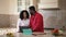 Busy stressed African American man talking surfing Internet on laptop with loving woman supporting spouse. Portrait of