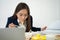 Busy and tired businesswoman eating spaghetti for lunch at the Desk office and working to deliver financial statements to a boss.