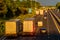 Busy traffic on uk motorway road overhead view at sunset