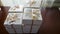 Busy woman make a stack of white boxes with handmade marshmallows for a buyers.