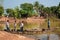 Busy workers passing the river through a boat. People are getting in to the boat to cross the lake.