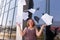 A busy young woman with papers in her hands, a happy business woman tosses the papers up