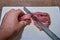 Butcher cuts meat with a knife on a cutting board