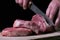 Butcher cutting beaf meat on kitchen. Food background