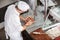 Butcher Cutting Meat With Bandsaw