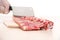 Butcher cutting meat on chopping board