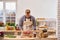 Butcher holding solid piece of pork steak meat on kitchen with vegetables background