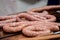 Butcher making sausages in meat factory