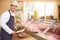 Butcher Preparing Meat In Shop