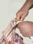 butcher\'s hands cutting pork meat, Closeup of ribs being cut in butcher kitchen