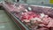butcher shop, raw fresh meat and offal inside refrigerated display case in trading area