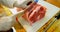 Butcher slicing meat on chopping board 4k