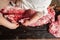 Butcher slicing piece pork carcass. Top view