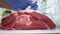 Butcher wearing Gloves on His Hands Preparing for Cutting a Piece of Beef Meat