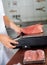 Butcher Weighing Meat On Weight Scale