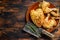 Butchered baked chicken on wooden table. Dark background. Top view. Copy space