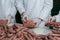 Butchers packing raw sausages