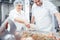 Butchers putting spices in minced meat