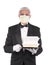 Butler in tuxedo wearing a covid-19 protective face mask holding a take-out food containers on a tray,  over white