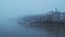 Butlers Wharf Pier and River Thames in thick fog and mist, on a cool blue morning in foggy and misty