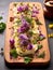 Butter board with herbs, spices and edible flowers. Starter for party, finger food. Top view. Trendy food concept. Butter spread