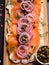 Butter board with smoked salmon, capers, red onions, spices and herbs. Starter for party, finger food. Top view. Trendy food