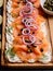 Butter board with smoked salmon, capers, red onions, spices and herbs. Starter for party, finger food. Top view. Trendy food