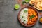 Butter chicken with rice served on grey table, flat lay