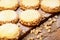 Butter cookies (alfajores) with caramel and peanut on wooden background.