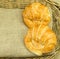 Butter croissant on gunny sack texture in wicker basket