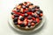 Butter enriched shortcrust pastry topped strawberries and blackberries, seasonal cake with colorful decoration