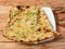 Butter garlic naan, isolated over a rustic wooden background, selective focus