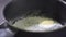 Butter Melting In Frying skillet. Close up shot of butter on black pan melting. Cooking home.